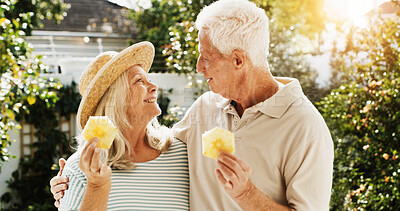 Buy stock photo Outdoor, laughing and senior couple with fruit, patio or bonding on break, wellness or healthy diet. Home, old woman and elderly man with pineapple on weekend, romance or people with humor for joke