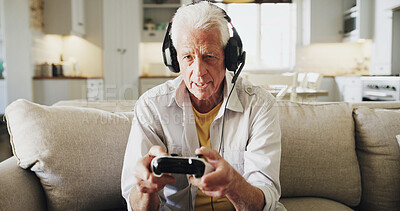 Buy stock photo Senior man, console and playing video games with headphones on sofa for online entertainment. Retirement fun, elderly gamer or male person with controller or headset for virtual competition in house