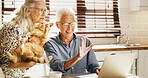 Retirement, online and senior couple with laptop on video call, digital and technology for connection. Happiness, network and people in kitchen with cat, internet and conversation for social media.