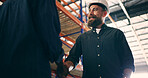 Handshake, meeting and shipping with man in warehouse for welcome, logistics manager and partnership. Delivery contract, low angle and shaking hands with people in factory do supply chain deal
