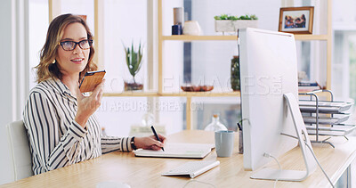 Buy stock photo Creative, woman and writing notes with phone in office for voice recording, story ideas and reminder. Journalist, notebook and listening to memo, schedule tips and article information for publication
