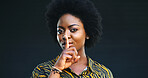 Black woman, portrait and finger with lips in studio for secret or rumor on a dark background. Private, female person or African model with afro for silence, gossip or confidential on mockup space