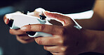 Hands, closeup and video game controller in home for esports challenge, click and strategy for next level. Person, gamer and console with tech, joystick and online contest with battle at apartment
