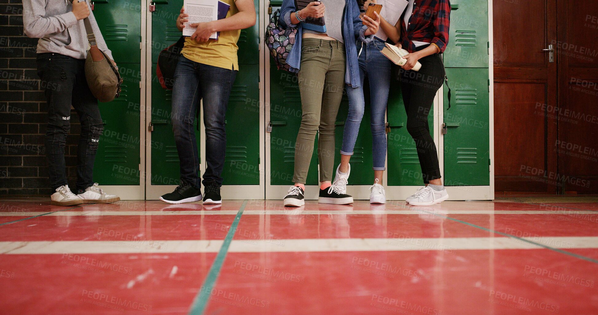 Buy stock photo Legs, group and high school kids in hallway by lockers, tech and floor with backpack for education. Friends, shoes and book bag with learning, development and scholarship in corridor at academy