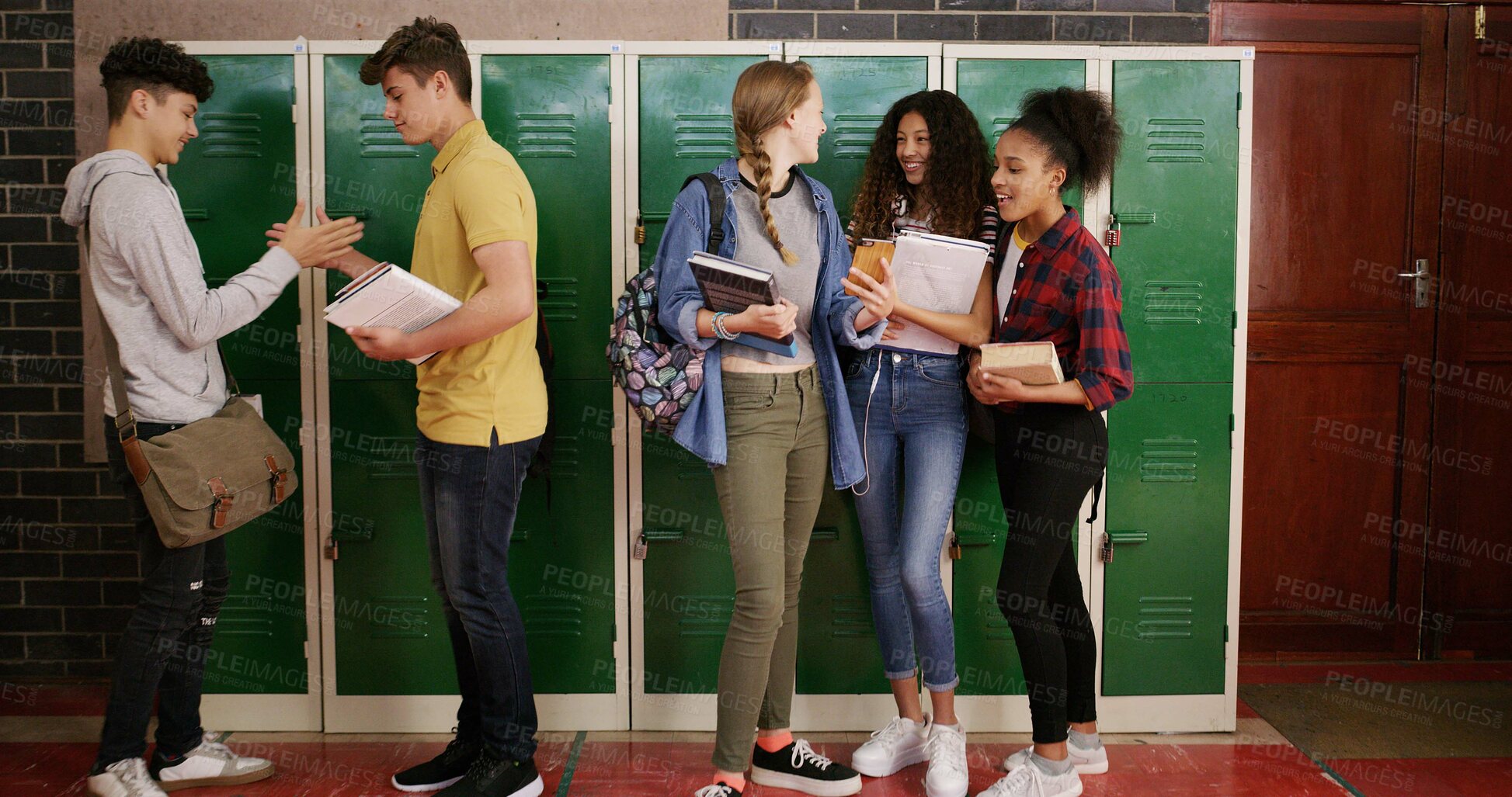 Buy stock photo Students, group and people at high school for story, gossip or learning at recess. Education, happy friends or teenagers in conversation on break by lockers with handshake, chat and laugh at campus