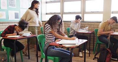 Buy stock photo Quiz, high school and teacher walking in classroom for assessment, exam and test supervision. Teaching, academy and woman with students writing assignment for education, learning and lesson progress