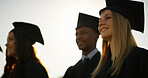 Smile, woman and students and graduation outdoor for education, celebration and class success. Below, people and waiting for degree of college achievement, award announcement and certificate ceremony