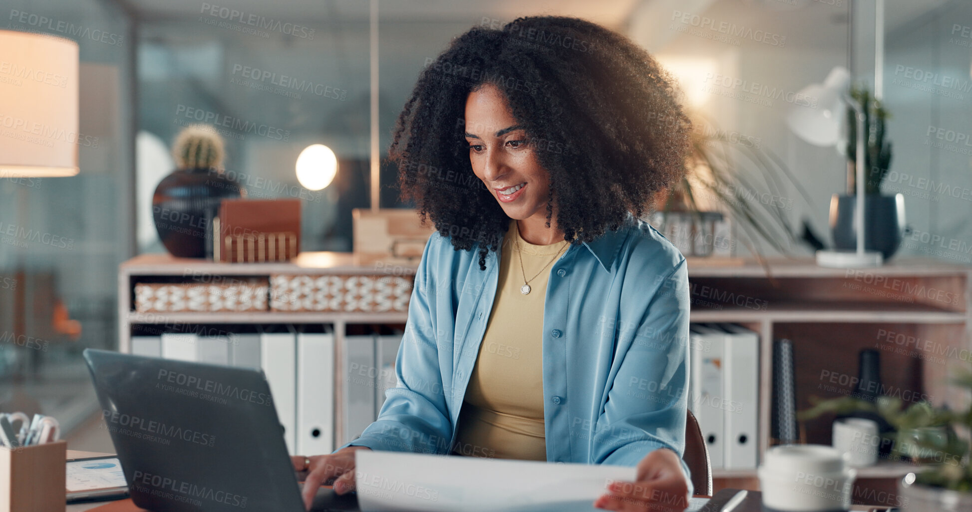 Buy stock photo Happy, employee and woman with laptop, office and working late for data entry, paperwork and online. Night, accountant and African person with financial report, smile or review document in business