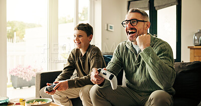 Buy stock photo Father, child and win video game with celebration, competition and parent with son in home. Happy kid, dad and success with console with fist pump, victory and bonding together with family in lounge