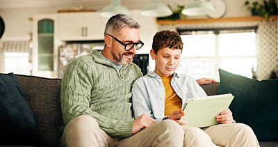 Buy stock photo Home, father and boy on couch, tablet and bonding together with online game, relax and learning. Help, family or dad with son, support and parent with tech, social media or app with child development