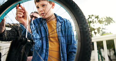 Buy stock photo Bike, maintenance of tyre and dad with son on patio for development, growth or learning. Repair, flat wheel and father teaching boy child how to fix bike outdoor in backyard for lesson together