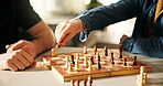 Playing, hands and father with kid for chess in home for learning, development or bonding. Teaching, competition and dad with boy child for board game with checkmate for problem solving skills.