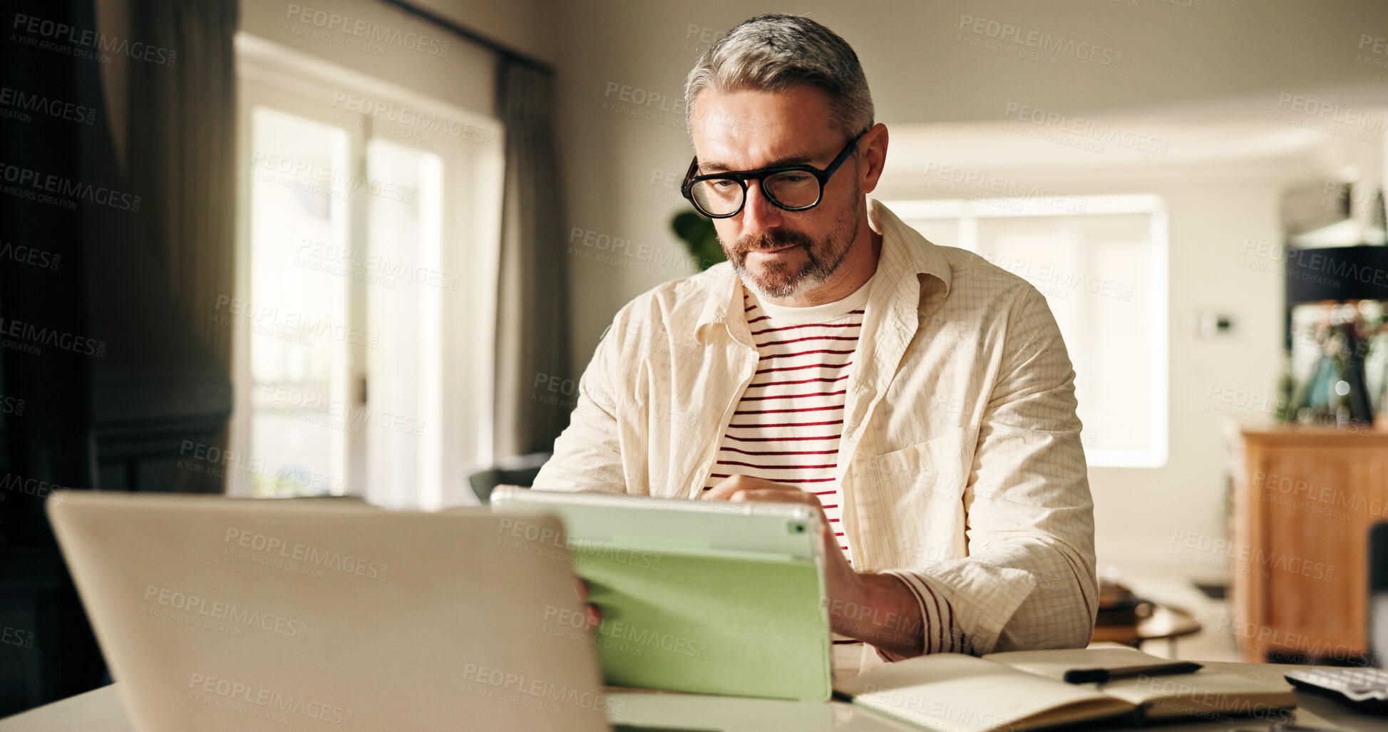 Buy stock photo Business, man or tablet with reading in home for publication review, remote work or story planning. Freelance writer, mature person or tech at desk for manuscript revision and proofreading newsletter