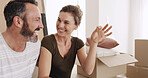 Excited, moving and couple with keys, new house or happy for mortgage approval, love and investment. Man, laughing and bonding with woman in lounge, boxes and purchase of home with loan and bond