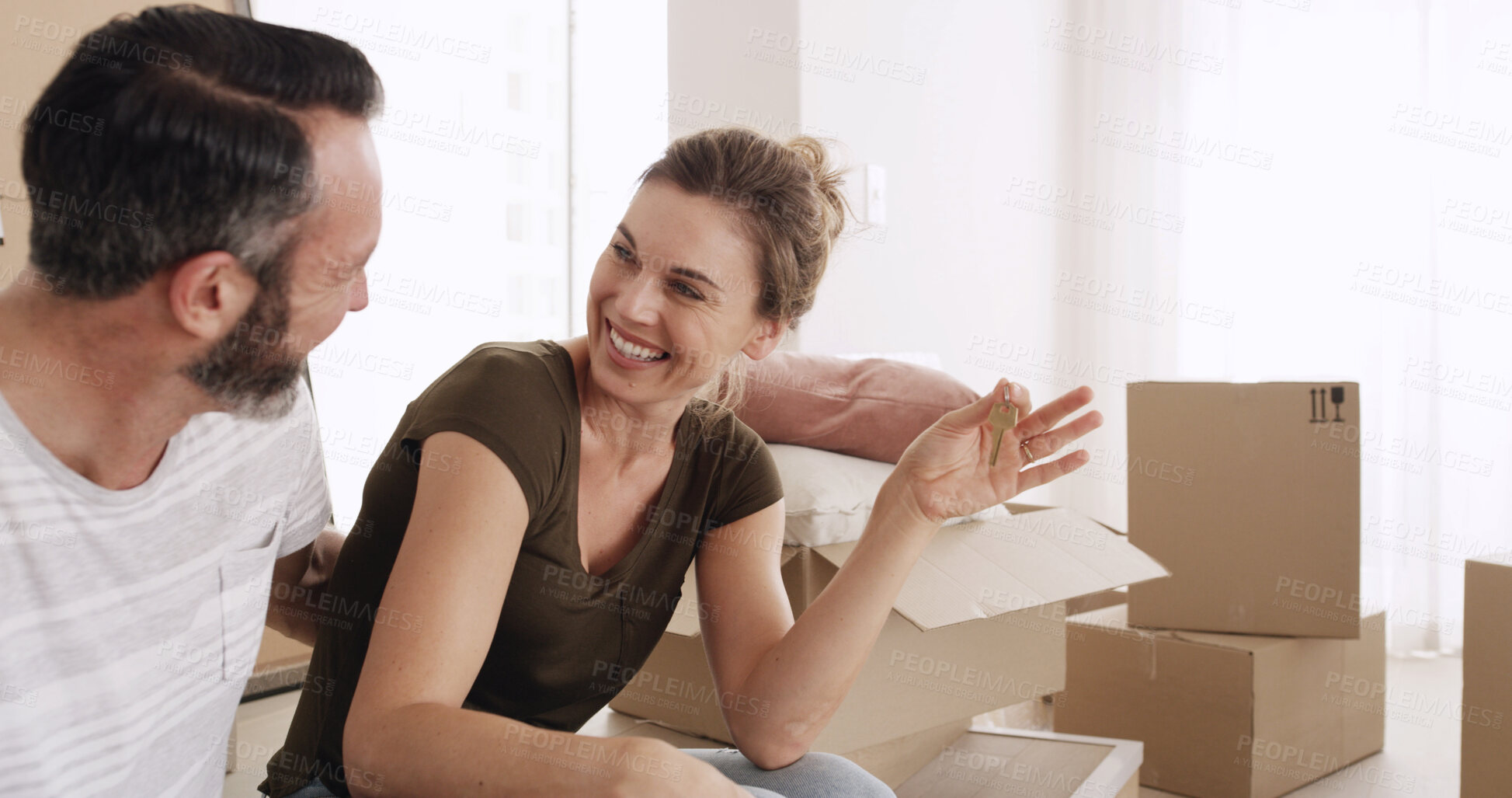 Buy stock photo Moving in, couple and happy with keys in new home for property purchase, relocation and investment. Boxes, mature man and excited woman with ownership of dream house for mortgage security and support