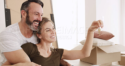 Buy stock photo New house, moving and couple with keys, love or happiness for mortgage approval, hug and investment. Man, affection and bonding with woman in lounge, excited and purchase of home with loan or bond