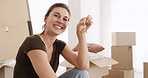 Happy woman, boxes and portrait with keys in property for investment, purchase or new home. Excited, female person or homeowner with smile, access or packages for fresh start, house or apartment sale
