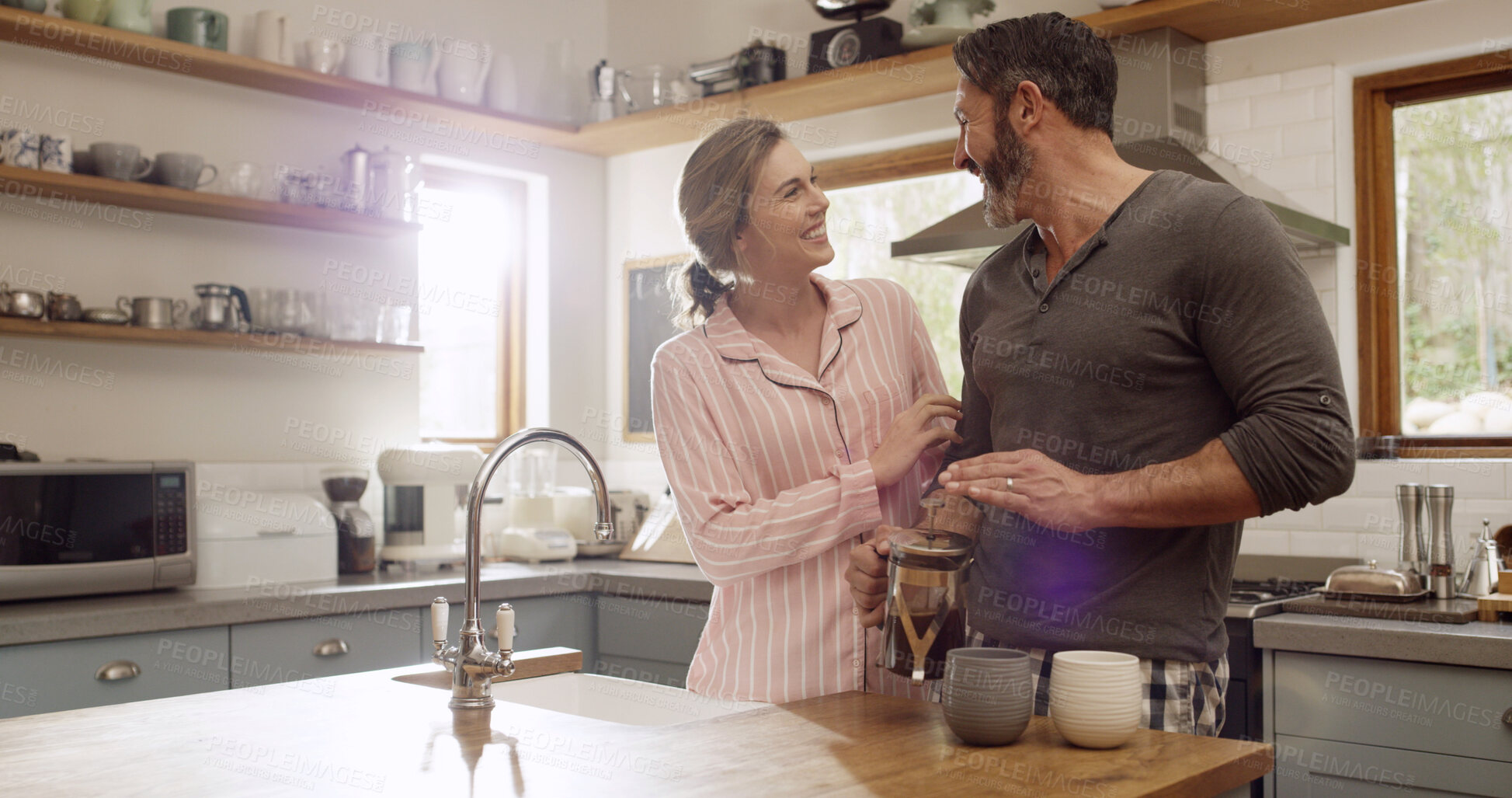 Buy stock photo Coffee, love and morning with couple in kitchen for smile, commitment and beverage mug. Happiness, support and drink with man and woman bonding in home for connection, marriage and break together