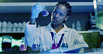 Laboratory, black woman and scientist with beaker for test, chemical research or DNA experiment. Biochemistry, science and medical chemist with liquid, inspection and cure development with blue light