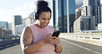 Phone, fitness and woman with music in city to listen to radio, audio and workout playlist. Headphones, runner and happy person on smartphone for health app, exercise tracker and training outdoor