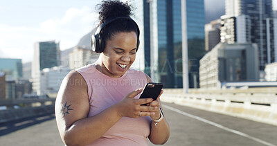 Buy stock photo Phone, fitness and woman with music in city to listen to radio, audio and workout playlist. Headphones, runner and plus size person on smartphone for health app, exercise tracker and training outdoor
