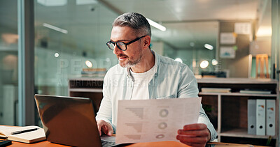 Buy stock photo Mature, businessman and night with documents on laptop for performance review or analysis in office. Man, financial advisor or working late with paperwork, statistics or report deadline in workplace