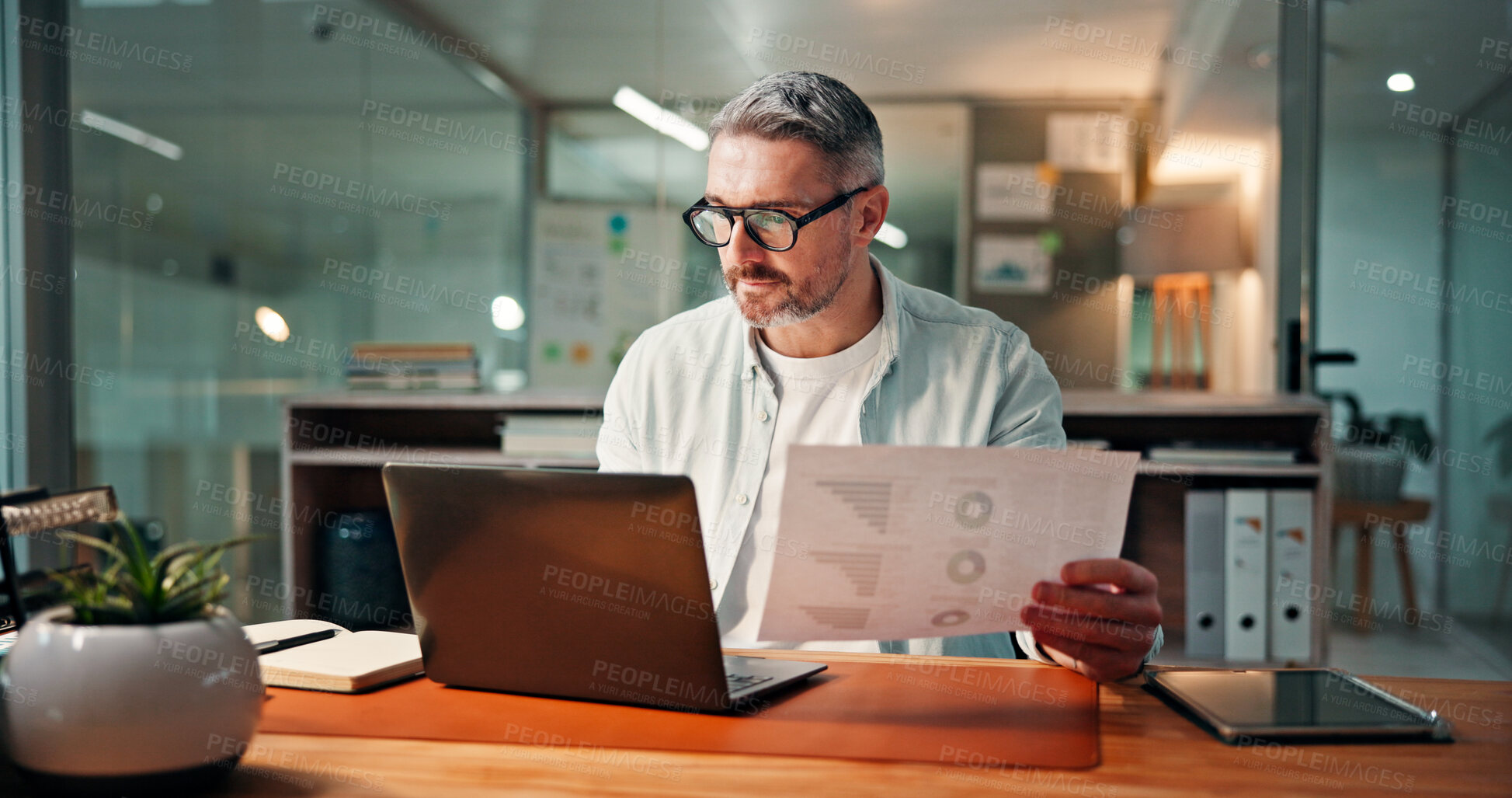 Buy stock photo Reading, laptop and documents with business man in office for budget research, planning and graph. Profit chart, account review and paperwork with person in agency for finance, balance and growth