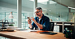 Reading, phone and scroll with business man in office for social media manager, email and contact. Campaign marketing, web and networking with mature person in creative agency for text message