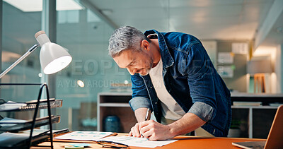 Buy stock photo Businessman, night and writing with documents for statistics, analysis or report in office. Man, analyst or working late with paperwork for company graph, performance review or analytics in workplace