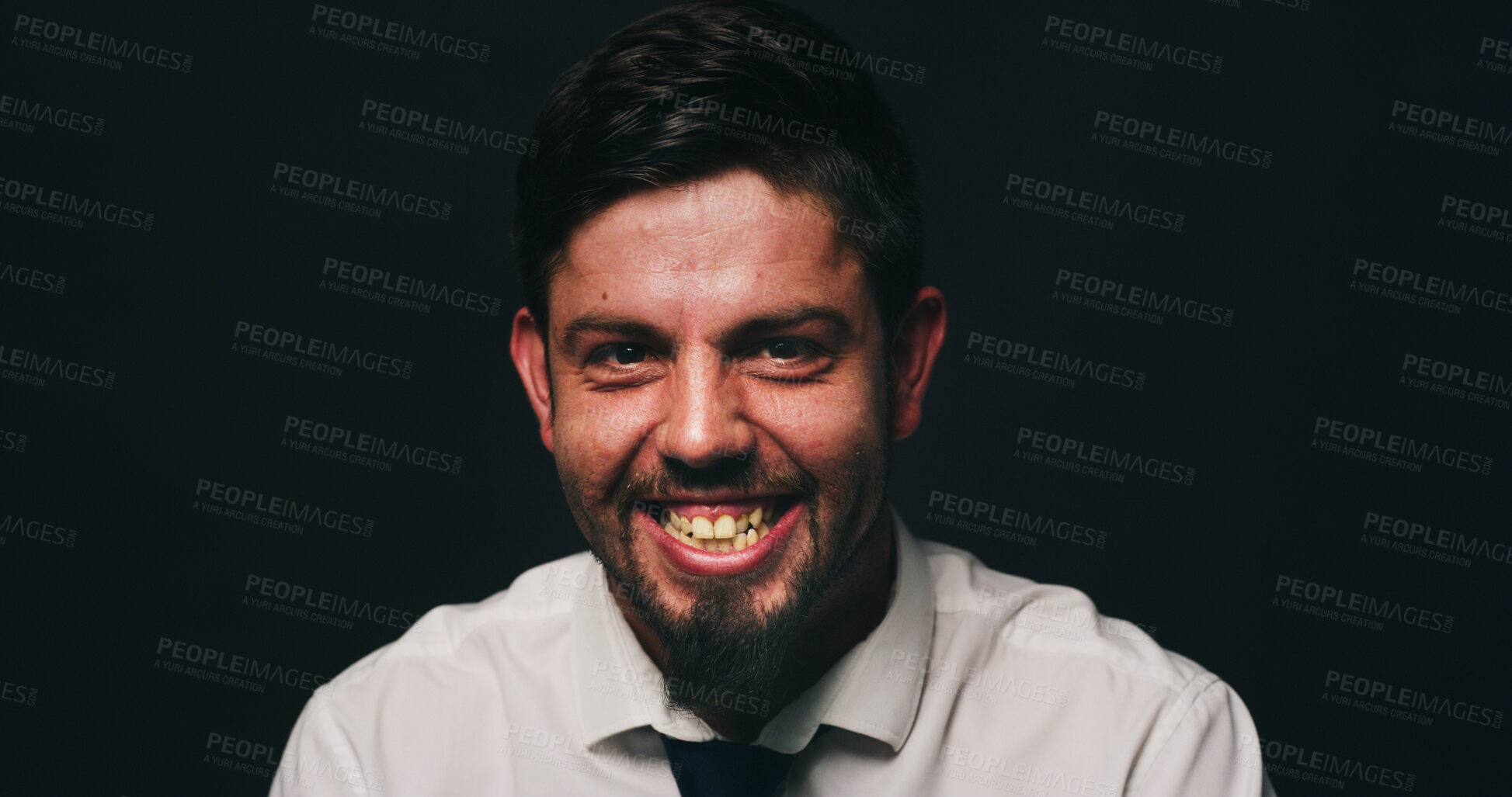 Buy stock photo Portrait, psychology or man in studio with bipolar, dark or isolated background for mental health. Laugh, manic or person in distress with smile, dismissal or fired in corporate for missed deadline.