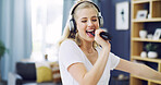 Karaoke, hair brush and music with woman in home for singing, streaming and soundtrack. Headphones, relax and radio subscription with person in living room of apartment for audio and dancing