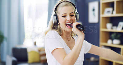Buy stock photo Karaoke, hair brush and music with woman in home for singing, streaming and soundtrack. Headphones, relax and radio subscription with person in living room of apartment for audio and dancing