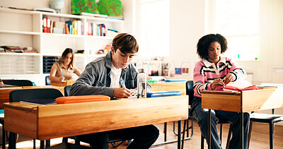 Buy stock photo People, teenager and writing with books in classroom for education, learning or development. Boy, students and studying with textbooks in class for knowledge, assessment or exam in high school