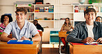 Boy, teenager and attention in classroom for education, information and tips for assessment at high school. Pupil, group and smile for development, scholarship and learning with course at academy