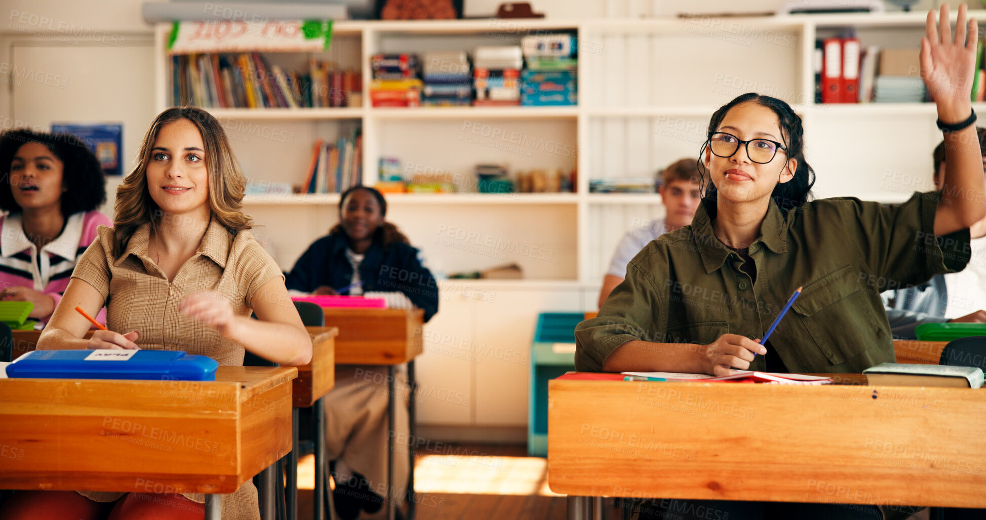 Buy stock photo Question, lesson and students in classroom at high school with learning, education or participation in class. Teen, group and girl with hand raised for knowledge, academic development and interaction