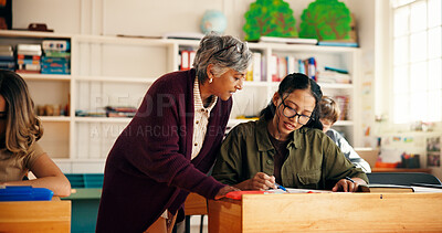 Buy stock photo Education, teacher and people in school at desk, help and communication in problem solving. Discussion, advice and mentor in classroom with stationary, engagement or assistance for curriculum support