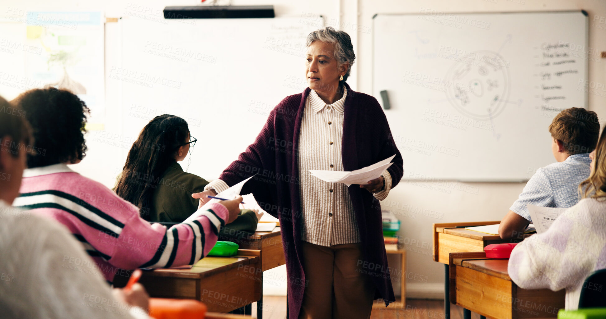 Buy stock photo Teacher, classroom and giving results for test with teen girl, pupil and paper for science assessment. Mature woman, children and documents for exam, quiz and learning for education at high school