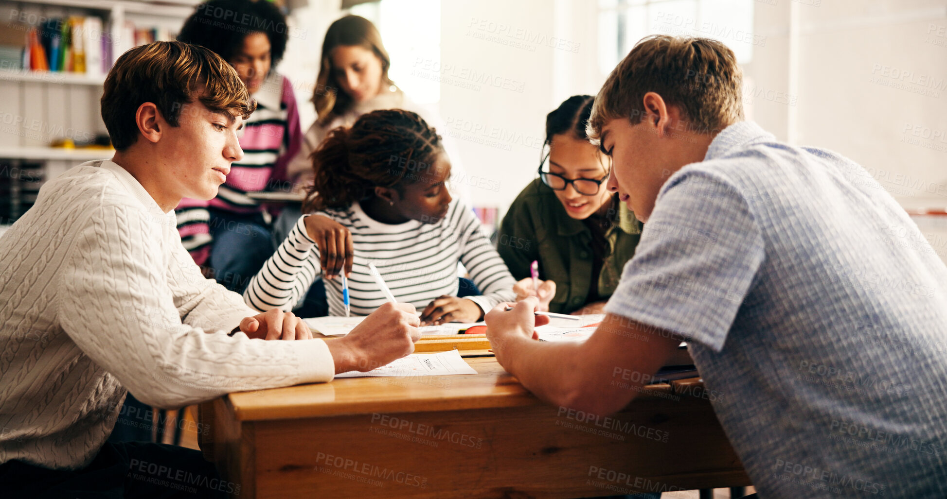 Buy stock photo Pupil, teen group and project at high school for teamwork, problem solving and study for exam. Children, girl and boy with books, writing or brainstorming with assessment for education at academy