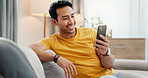 Happy, video call and man on sofa with phone for connection, social networking and online chat. Relax, weekend and person on smartphone for communication, internet and conversation on mobile app