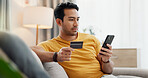 Online shopping, credit card and man with phone on sofa for digital purchase, payment and subscription. Home, relax and person with debit info on tech for ecommerce, website sale and internet banking