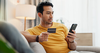 Buy stock photo Online shopping, credit card and man with phone on sofa for digital purchase, payment and subscription. Home, relax and person with debit info on tech for ecommerce, website sale and internet banking