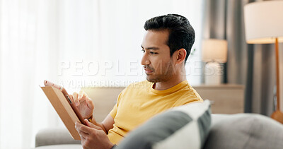 Buy stock photo Tablet, relax and man in home for social media post, internet and reading news. Technology, living room and person with app for browsing online forum, communication and check email with notification