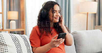 Buy stock photo Phone, music and relax with woman on sofa for streaming service, audio app and connection. Online song album, radio subscription and headphones with person in living room of home for sound and break