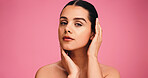 Skincare, cosmetics and portrait of woman in studio with natural, beauty or facial glow. Serious, confident and female person from Brazil with face dermatology for wellness by pink background.