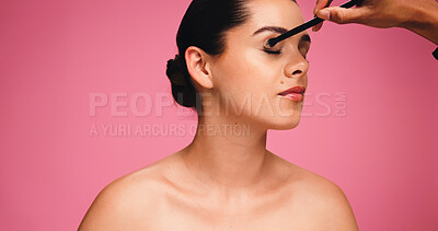 Buy stock photo Woman, hand and brush for makeup in studio for beauty, eyeshadow and cosmetics routine. Person, artist and mockup space with tools for makeover, facial transformation and grooming on pink background