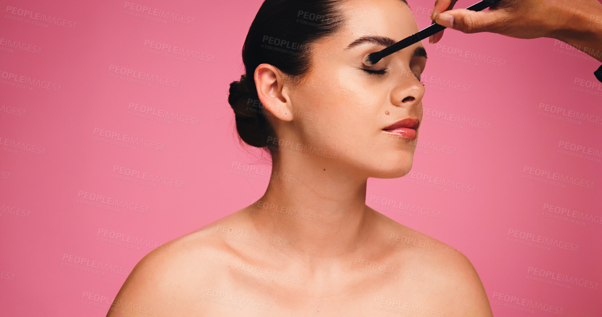 Buy stock photo Woman, hand and brush for makeup in studio for beauty, eyeshadow and cosmetics routine. Person, artist and mockup space with tools for makeover, facial transformation and grooming on pink background