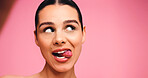Beauty, face and woman in studio with cosmetics, tongue out or microblading for self care. Mockup space, selfie or person with glowing skin, procedure results or facial cosmetology on pink background