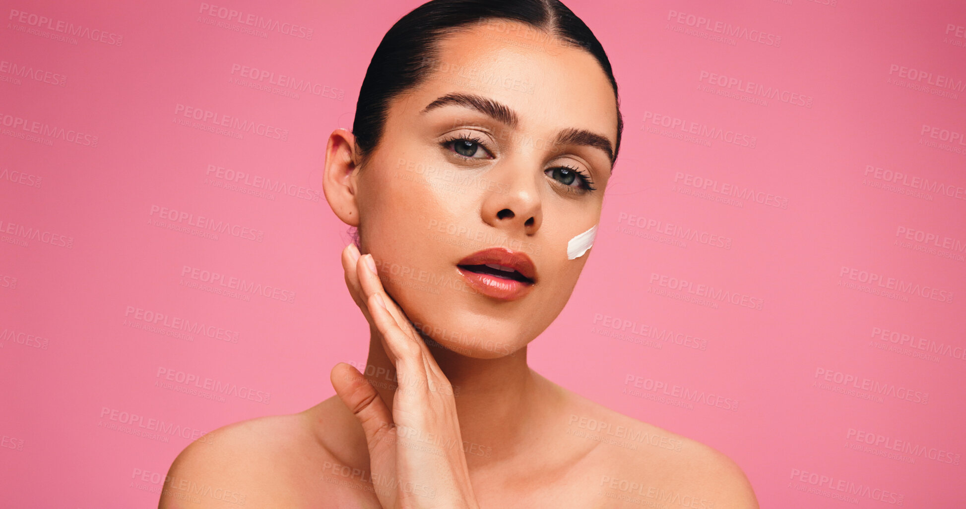 Buy stock photo Beauty, face cream and portrait of woman in studio with natural, cosmetics or facial glow. Moisturizer, mockup space and female person from Brazil with dermatology for wellness by pink background