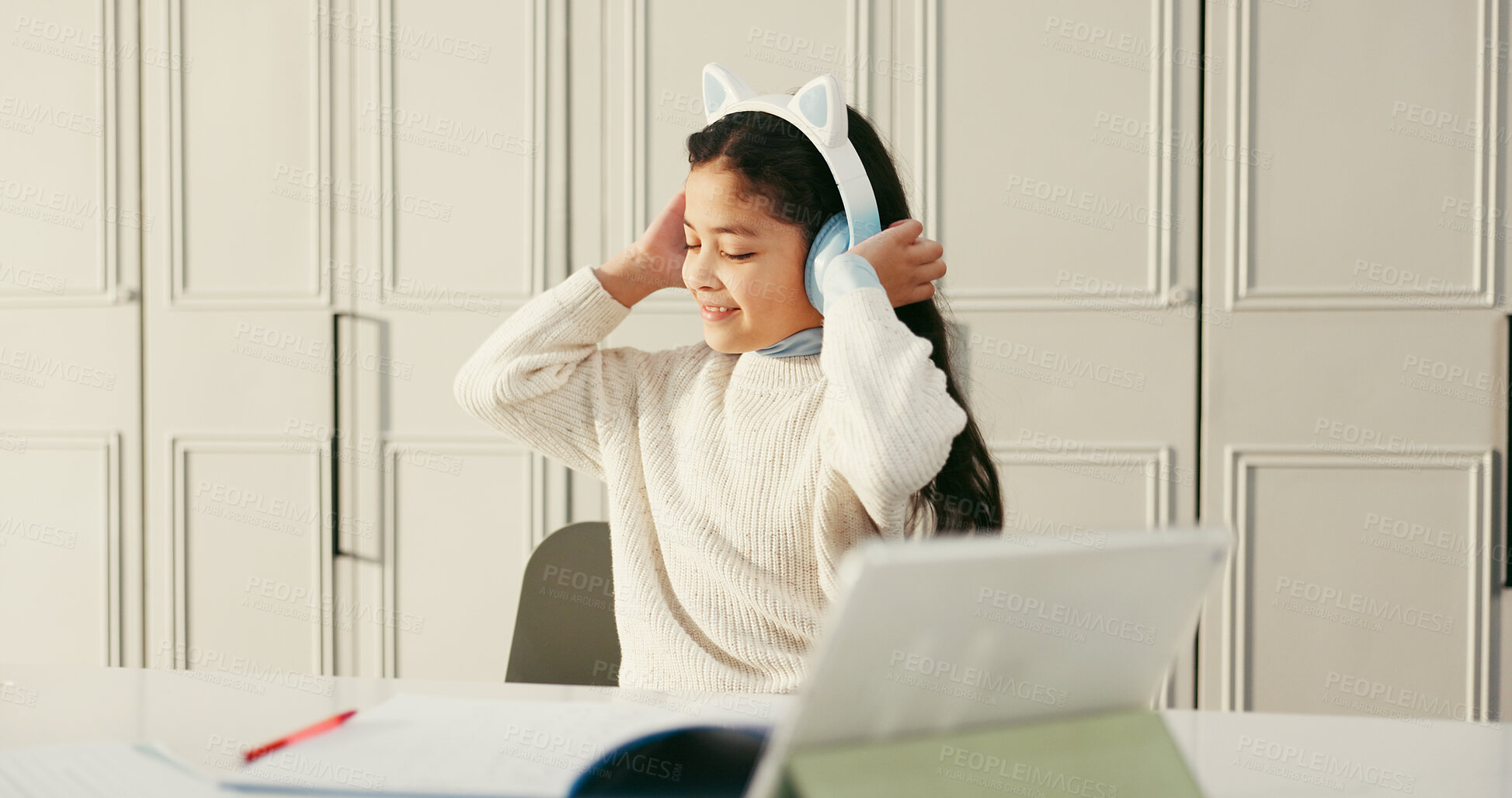 Buy stock photo Homework, girl and kid with headphones, tablet and education with audio, sound and relax. Apartment, student and headset with album playlist, song and listening to music, studying and knowledge