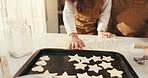 Baking, hands and cookies on tray in kitchen for teaching, bonding or fun activity together in home. Learning, cooking and people preparing dessert or biscuits on counter for development in house.
